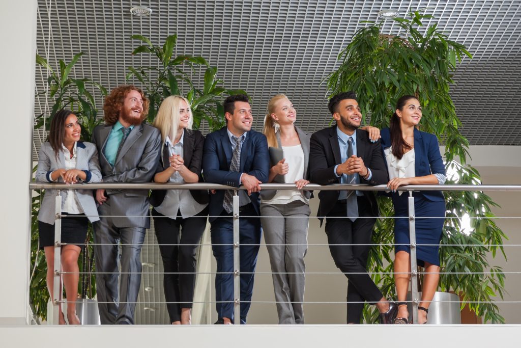 Team of people standing up and happy