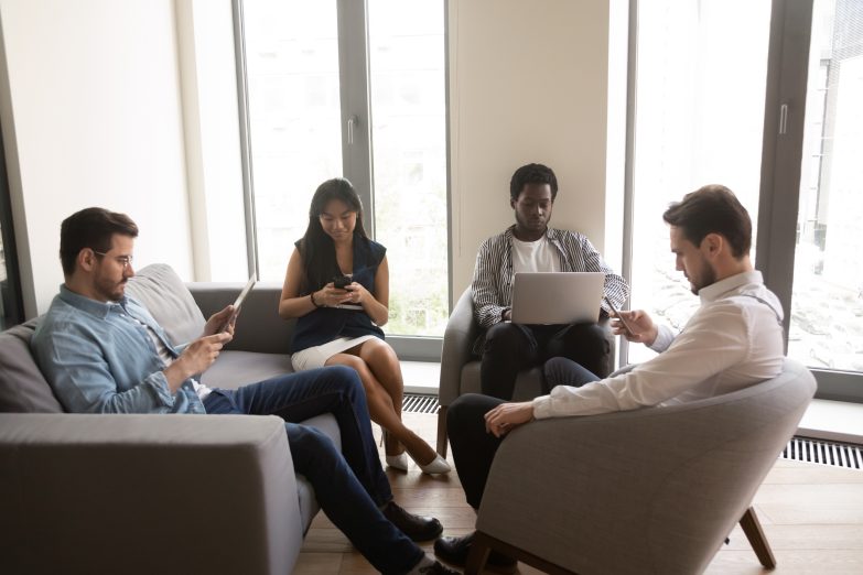 Sitting and smiling team of office workers