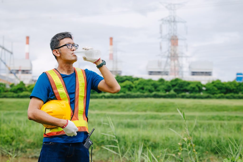 An outdoor worker is taking a break to avoid heat illness.