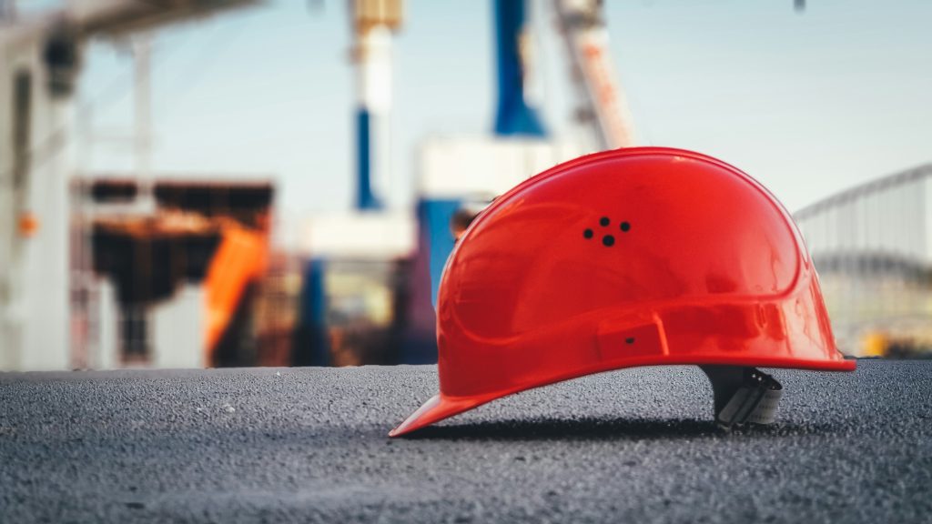 An orange helmet resting on the ground
